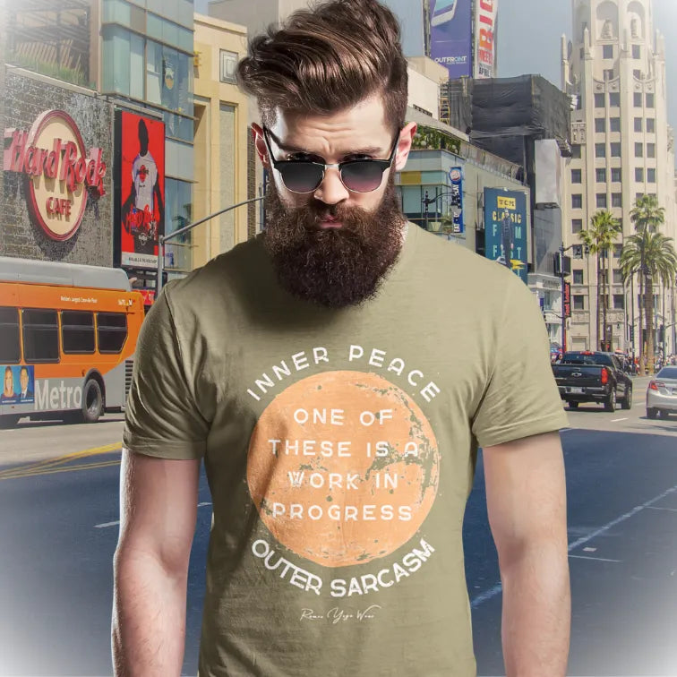 Person wearing the Sarcasm T-Shirt in Heather Olive, standing outdoors on a city street — Funny Yoga Shirts collection by Ramro Yoga Wear.