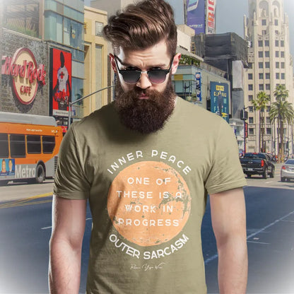 Person wearing the Sarcasm T-Shirt in Heather Olive, standing outdoors on a city street — Funny Yoga Shirts collection by Ramro Yoga Wear.