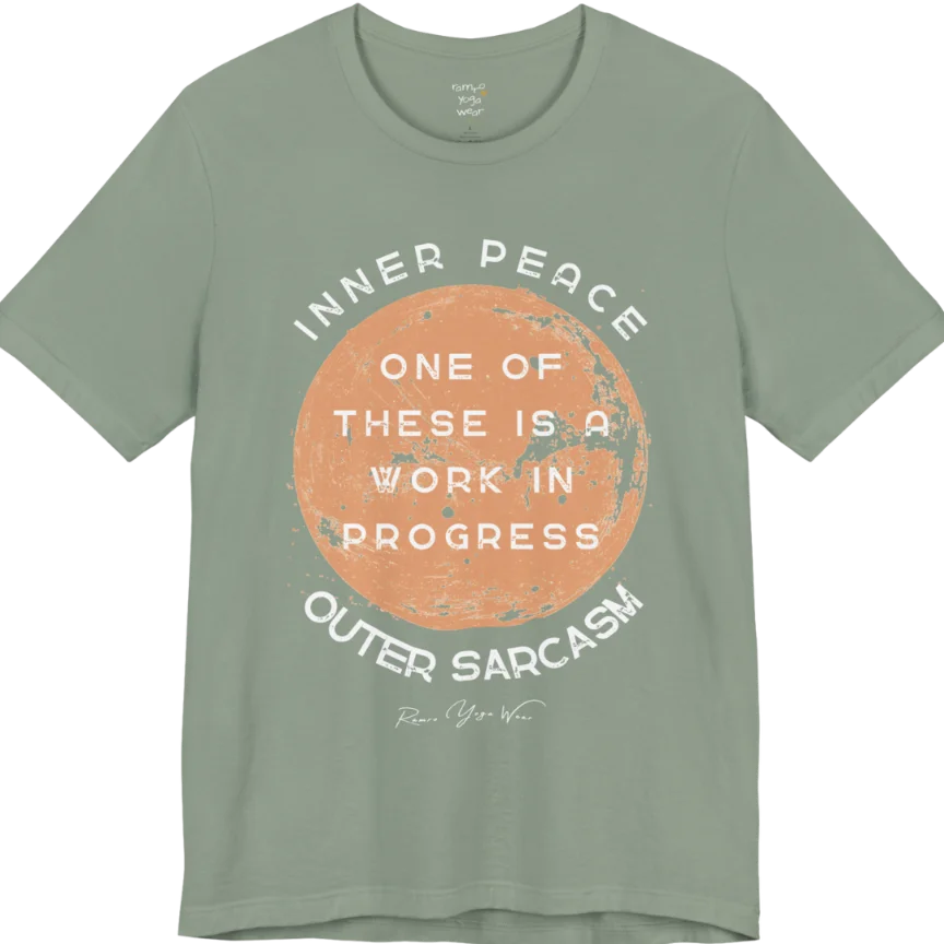 A grunge tee with a sun-washed circular design, text reading "Inner Peace," "One of these is a work in progress," and "Outer Sarcasm" — Funny Yoga Shirts collection by Ramro Yoga Wear in Sage.