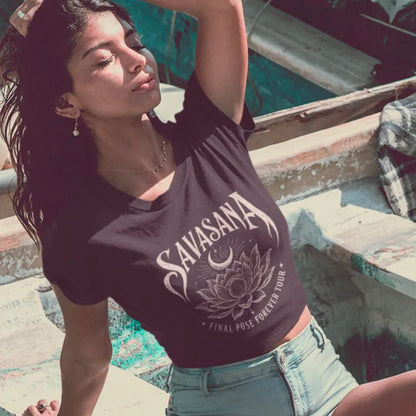 Savasana T-Shirt in Dark Chocolate worn by woman relaxing outdoors featuring yoga-inspired lotus artwork and soulful vintage aesthetic.