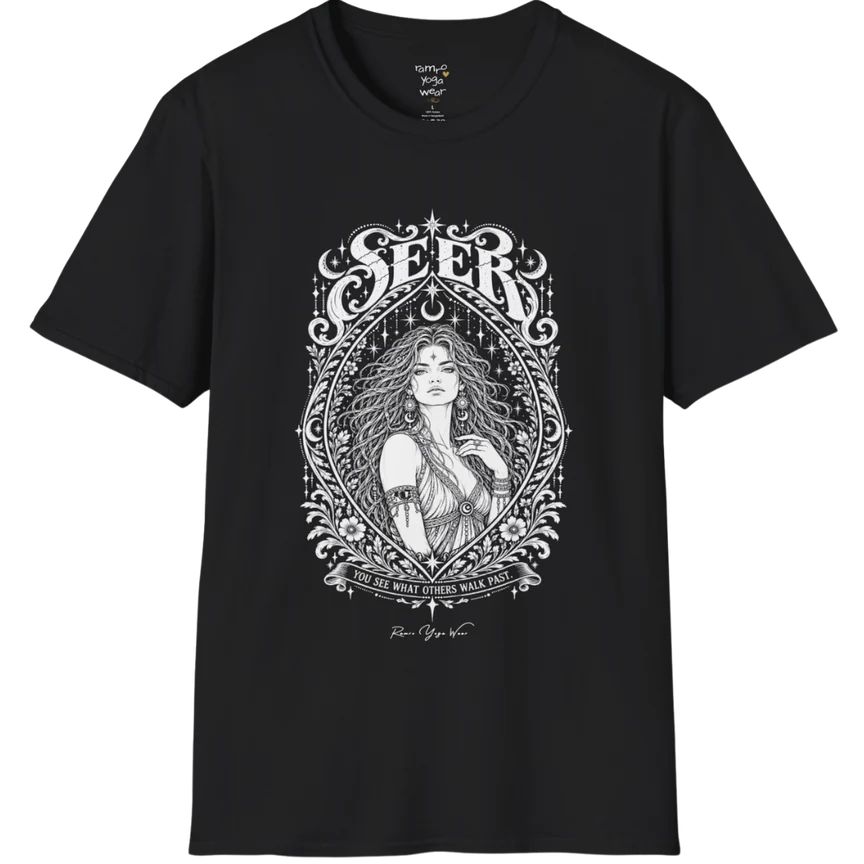 A short sleeved tee called the Seer T-Shirt, flat lay and a soft cotton shirt. Simply says, You see what others walk past. Design highlights an ornate engraved almond-shaped frame of florals and filigree around a close portrait of a long-haired figure with a star on the brow, crescent moon earrings and one hand at the collarbone, beneath a crescent moon and hanging stars, with Seer in decorative lettering across the top and the tagline on a banner below. Color is Black.