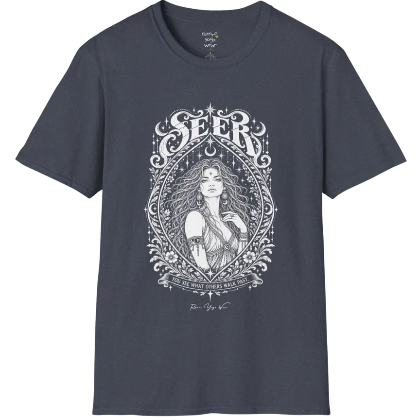 A short sleeved tee called the Seer T-Shirt, flat lay and a soft cotton blend shirt. Simply says, You see what others walk past. Design highlights an ornate engraved almond-shaped frame of florals and filigree around a close portrait of a long-haired figure with a star on the brow, crescent moon earrings and one hand at the collarbone, beneath a crescent moon and hanging stars, with Seer in decorative lettering across the top and the tagline on a banner below. Color is Heather Navy.