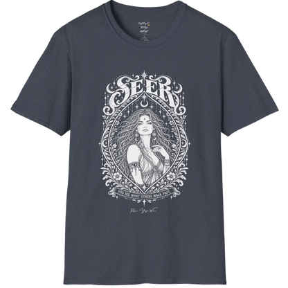 A short sleeved tee called the Seer T-Shirt, flat lay and a soft cotton blend shirt. Simply says, You see what others walk past. Design highlights an ornate engraved almond-shaped frame of florals and filigree around a close portrait of a long-haired figure with a star on the brow, crescent moon earrings and one hand at the collarbone, beneath a crescent moon and hanging stars, with Seer in decorative lettering across the top and the tagline on a banner below. Color is Heather Navy.