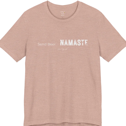 "Send Beer" in small script, followed by a  bold "NAMASTE" lettering. Send Beer T-Shirt flat lay is a Bella+Canvas 3001 and the color is Heather Prism Peach.