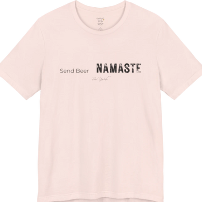 "Send Beer" in small script, followed by a  bold "NAMASTE" lettering. Send Beer T-Shirt flat lay is a Bella+Canvas 3001 and the color is Soft Pink.