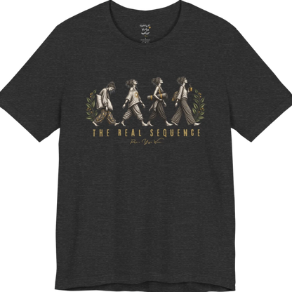 Four illustrated figures walking in sequence — pillow, sunburst top, rolled yoga mat, and coffee cup — framed by botanical leaf sprigs. Sequence T-Shirt flat lay is a Bella+Canvas 3001 and the color is Dark Grey Heather.