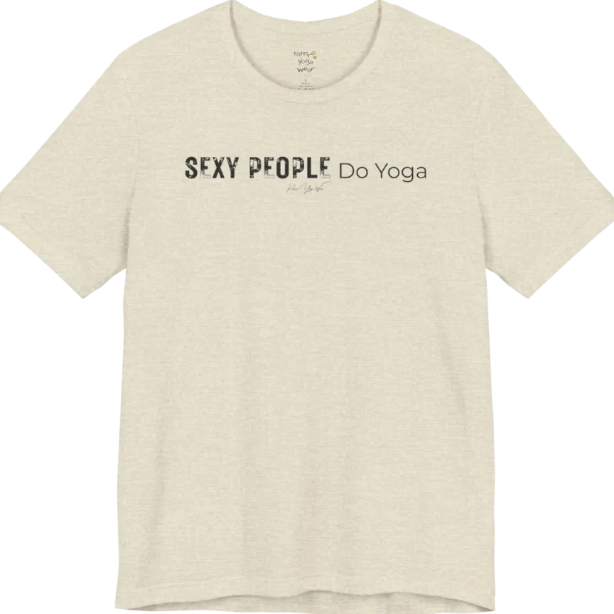 A short sleeved tee called the Sexy T-Shirt, flat lay and a soft cotton shirt. Simply says, Sexy People Do Yoga. Design highlights bold distressed block lettering for Sexy People beside lighter thin lettering for Do Yoga, with a small script signature underneath. Color is Heather Prism Natural.