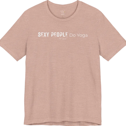 A short sleeved tee called the Sexy T-Shirt, flat lay and a soft cotton shirt. Simply says, Sexy People Do Yoga. Design highlights bold distressed block lettering for Sexy People beside lighter thin lettering for Do Yoga, with a small script signature underneath. Color is Heather Prism Peach.