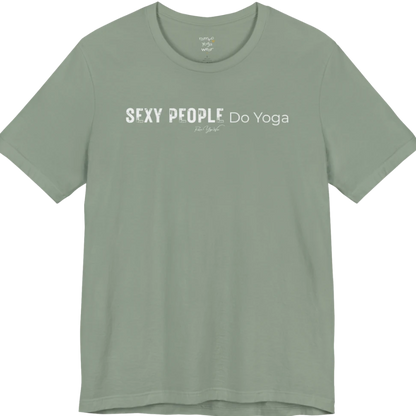 A short sleeved tee called the Sexy T-Shirt, flat lay and a soft cotton shirt. Simply says, Sexy People Do Yoga. Design highlights bold distressed block lettering for Sexy People beside lighter thin lettering for Do Yoga, with a small script signature underneath. Color is Sage.