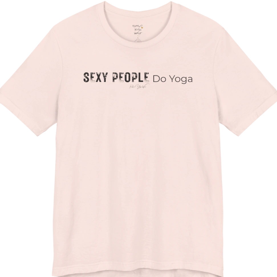 A short sleeved tee called the Sexy T-Shirt, flat lay and a soft cotton shirt. Simply says, Sexy People Do Yoga. Design highlights bold distressed block lettering for Sexy People beside lighter thin lettering for Do Yoga, with a small script signature underneath. Color is Soft Pink.