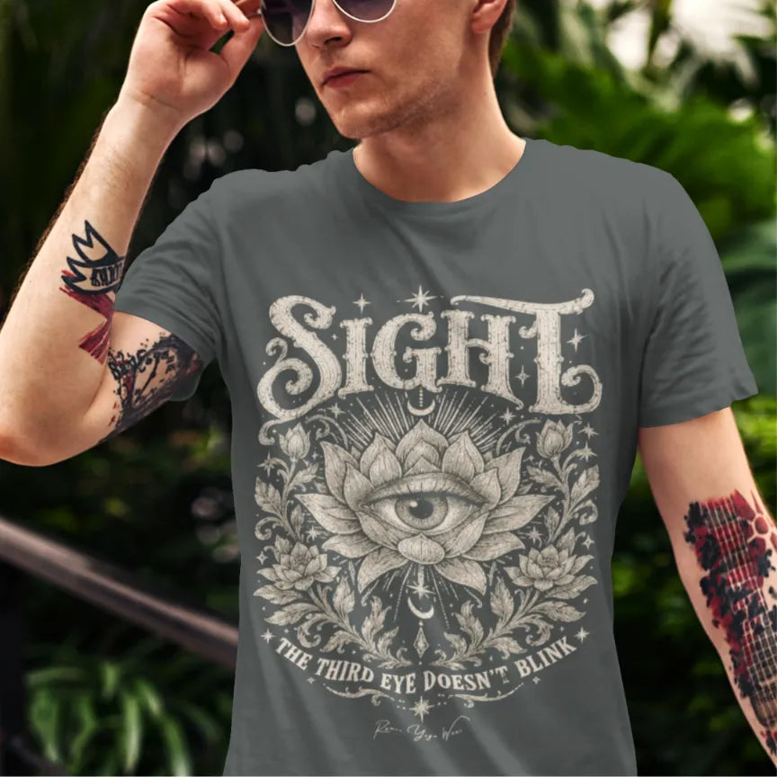 Man wearing the short sleeved Sight T-Shirt outdoors among greenery, adjusting his sunglasses, shirt in Dark Heather Grey.