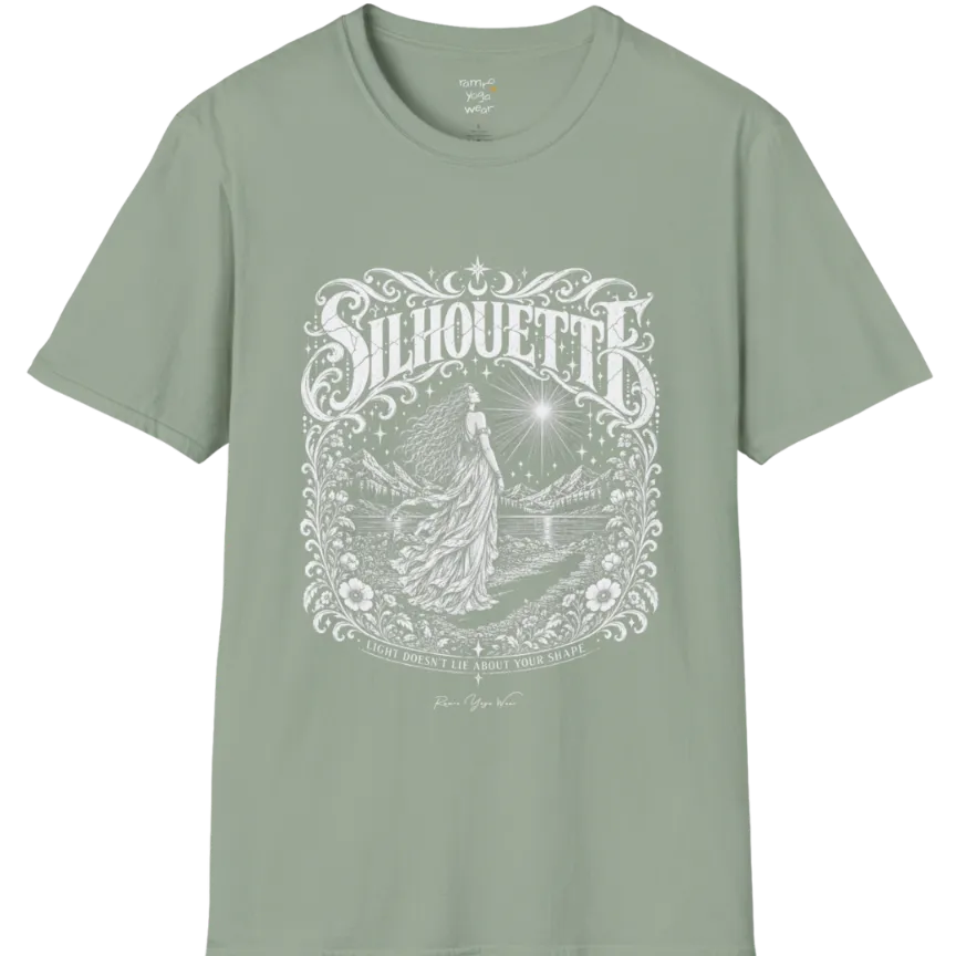 A short sleeved tee called the Silhouette T-Shirt, flat lay and a Gildan 64000 shirt on a white background. Simply says, Light Doesn't Lie About Your Shape. Design highlights a long-haired figure in a flowing gown gazing at a radiating star, framed by ornate florals, mountains and a lake, with the figure's cast shadow on the path. Color is Sage.
