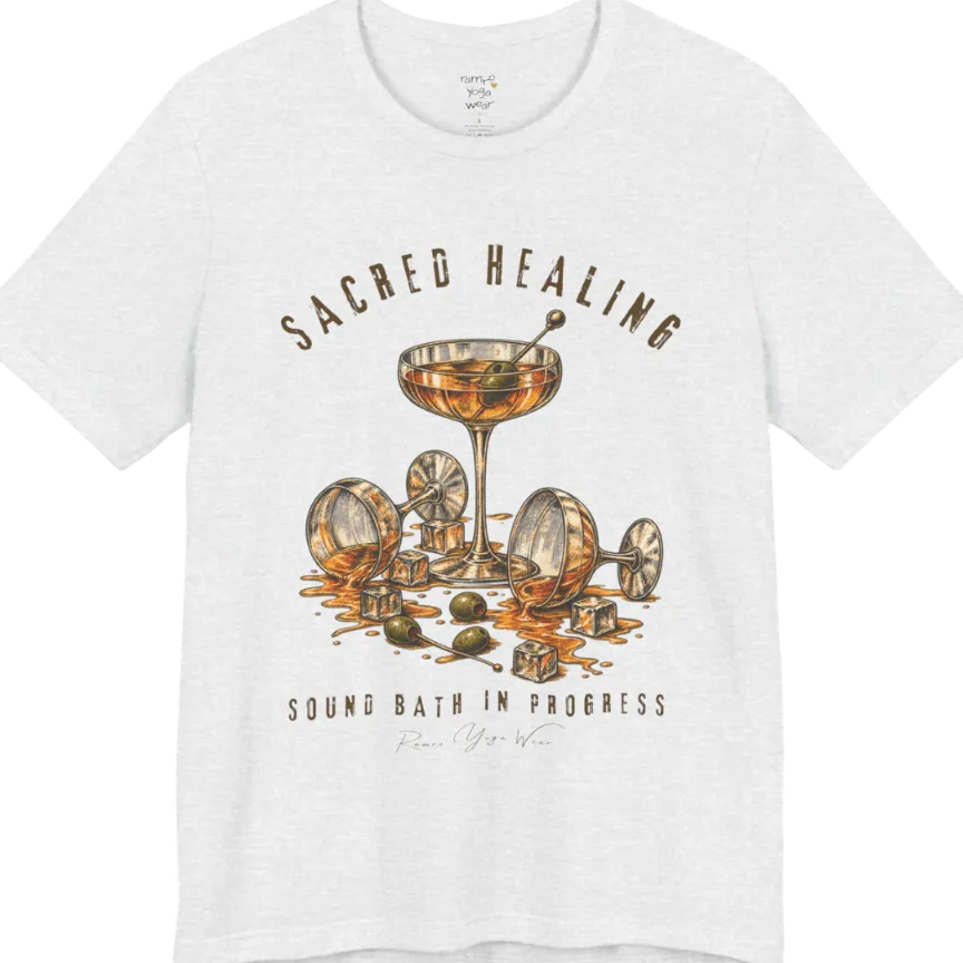 A grunge tee with an illustrated design of three cocktail glasses — one upright, two spilled with ice cubes and olives scattered — text reading "Sacred Healing" and "Sound Bath In Progress" — Funny Yoga Shirts collection by Ramro Yoga Wear in Ash.