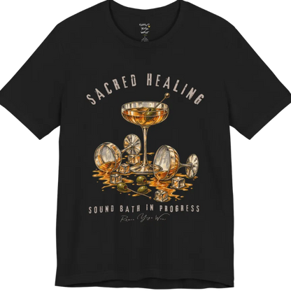 A grunge tee with an illustrated design of three cocktail glasses — one upright, two spilled with ice cubes and olives scattered — text reading "Sacred Healing" and "Sound Bath In Progress" — Funny Yoga Shirts collection by Ramro Yoga Wear in Black.