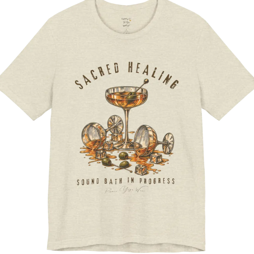 A grunge tee with an illustrated design of three cocktail glasses — one upright, two spilled with ice cubes and olives scattered — text reading "Sacred Healing" and "Sound Bath In Progress" — Funny Yoga Shirts collection by Ramro Yoga Wear in Heather Natural Prism.