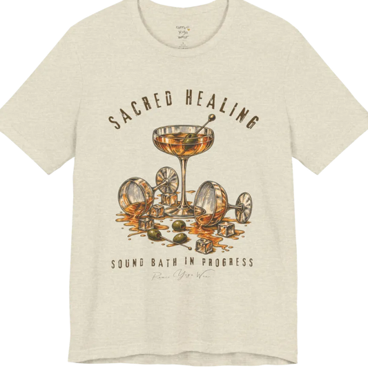 A grunge tee with an illustrated design of three cocktail glasses — one upright, two spilled with ice cubes and olives scattered — text reading "Sacred Healing" and "Sound Bath In Progress" — Funny Yoga Shirts collection by Ramro Yoga Wear in Heather Natural Prism.