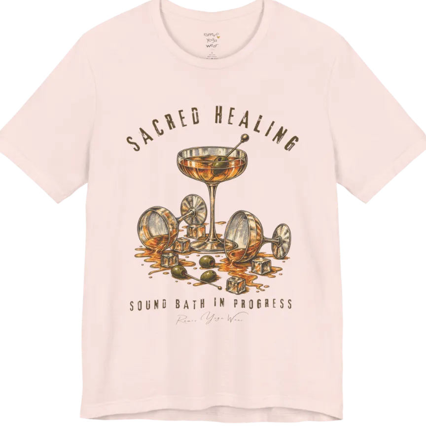 A grunge tee with an illustrated design of three cocktail glasses — one upright, two spilled with ice cubes and olives scattered — text reading "Sacred Healing" and "Sound Bath In Progress" — Funny Yoga Shirts collection by Ramro Yoga Wear in Soft Pink