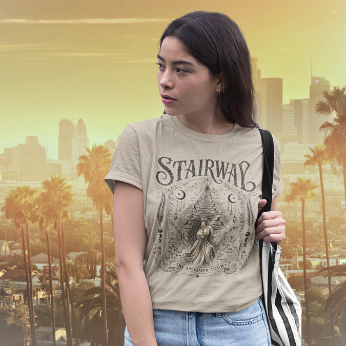 Woman wearing Stairway sand sacred yoga shirt in Los Angeles with palm trees and city skyline at golden hour — Sacred Thread collection by Ramro Yoga Wear