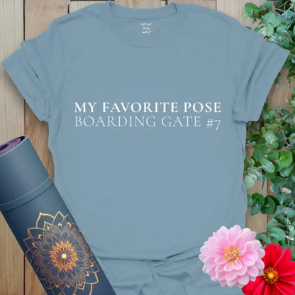 Stone Blue Boarding Gate T-Shirt with crisp white lettering: “My Favorite Pose — Boarding Gate #7.” Yoga and travel themed tee in muted blue.
