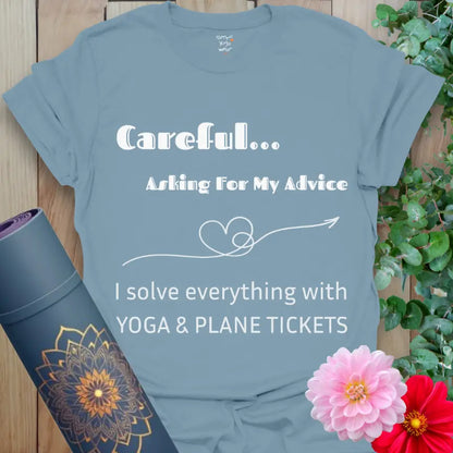 Stone Blue Careful T-Shirt with the quote “Careful… Asking For My Advice. I solve everything with yoga & plane tickets,” featuring a heart-arrow line art. Yoga and travel humor tee.