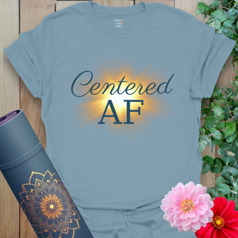 Stone Blue Centered AF T-Shirt featuring peaceful text and a golden radiance. Perfect for yogis who flow with strength and inner stillness.