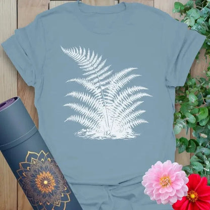 Muted stone blue yoga t-shirt with white fern design embodying earth connection and soulful movement.