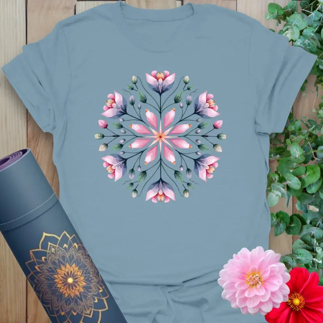 Muted stone blue yoga t-shirt featuring symmetrical floral mandala artwork inspiring mindful movement and peaceful living.