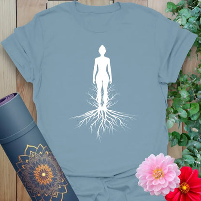 Muted stone blue yoga t-shirt with serene rooted figure artwork celebrating grounded living and soulful expansion.
