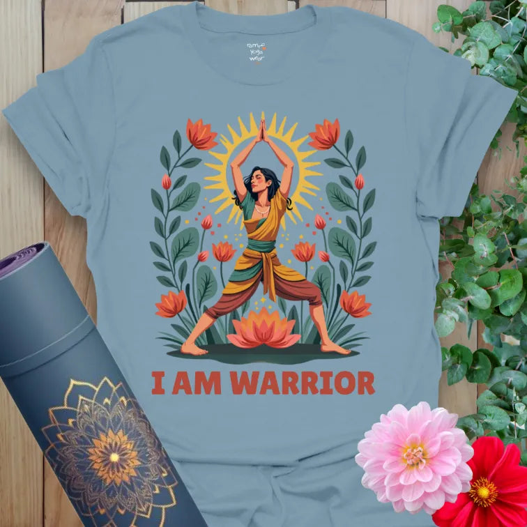 Muted stone blue yoga t-shirt featuring colorful Warrior Pose yogi surrounded by lotuses and sunshine, symbolizing inner courage and soulful growth.