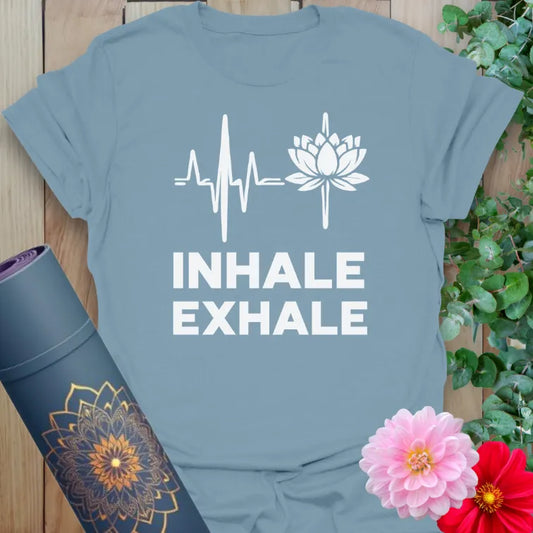 Muted stone blue yoga t-shirt with serene "Inhale Exhale" lotus graphic symbolizing peace, breath, and soulful living.