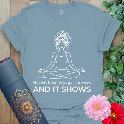 Stone Blue It Shows T-Shirt featuring serene line art of a yogi with messy bun and witty post-practice quote.
