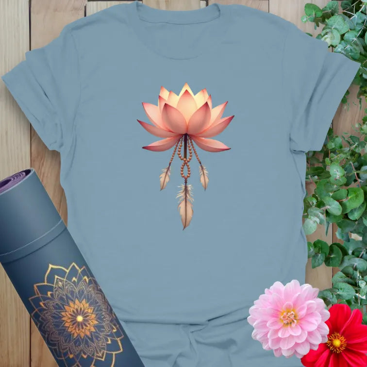 Muted stone blue yoga t-shirt featuring sacred lotus and feather design symbolizing purity, peace, and graceful expansion.