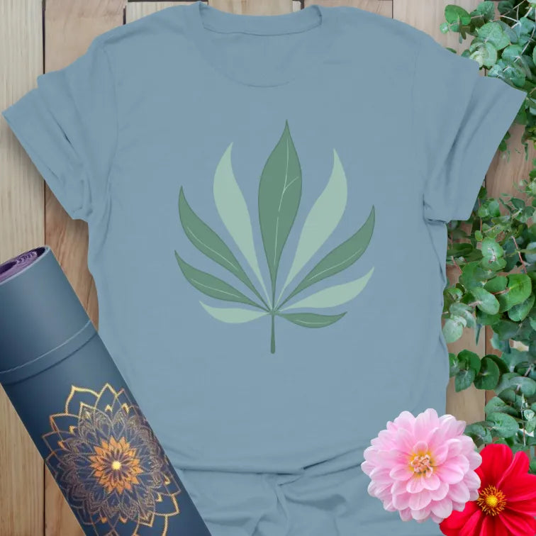 Muted stone blue yoga t-shirt showcasing palm leaf symbol representing natural balance, mindful movement, and soulful growth.
