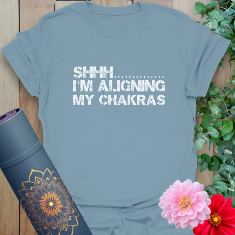 Muted stone blue yoga t-shirt with chakra alignment humor quote for joyful, peaceful, and soulful living.