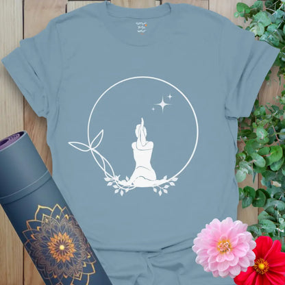 tone Blue Solitude T-Shirt with white meditating silhouette in leafy circle and stars. Everyday yoga tee for peace and mindfulness.