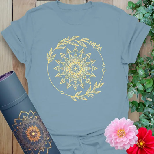 Muted stone blue yoga tee featuring golden sun mandala wrapped in leaves for inner light and nature-inspired balance.