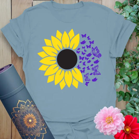 Muted stone blue yoga tee with yellow sunflower and violet butterflies representing renewal, joy, and mindful change