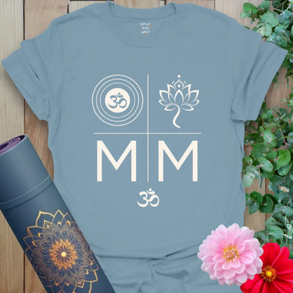 Stone Blue tee with cream spiritual symbols — Om in rings, lotus, mirrored M’s and mantra energy. Bold and balanced.