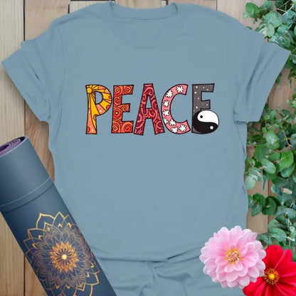 Muted stone blue t-shirt featuring artistic peace text with yin yang element for expressive, soulful wear.