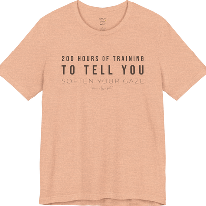 200 HOURS OF TRAINING TO TELL YOU SOFTEN YOUR GAZE yoga teacher gift tee flat lay in Heather Peach — Yoga Teacher Gifts collection by Ramro Yoga Wear