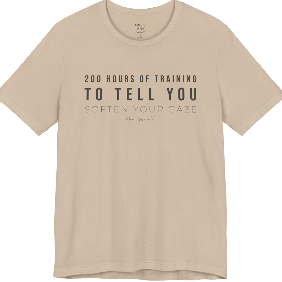 200 HOURS OF TRAINING TO TELL YOU SOFTEN YOUR GAZE yoga teacher gift tee flat lay in Tan — Yoga Teacher Gifts collection by Ramro Yoga Wear