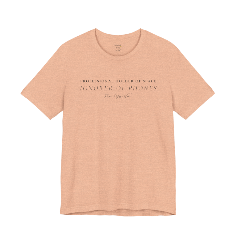 PROFESSIONAL HOLDER OF SPACE IGNORER OF PHONES yoga teacher gift tee flat lay in Heather Peach — Yoga Teacher Gifts collection by Ramro Yoga Wear