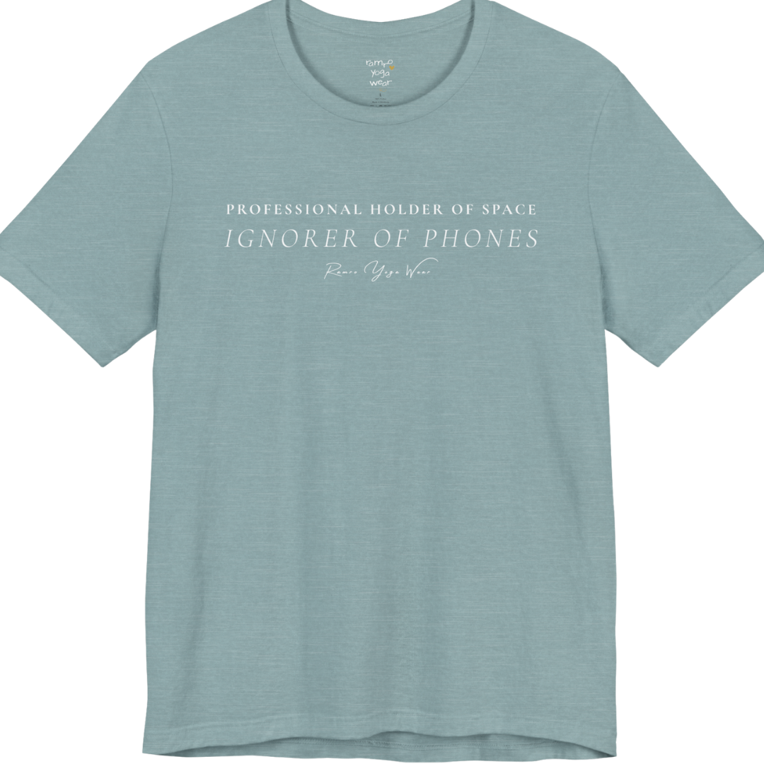 PROFESSIONAL HOLDER OF SPACE IGNORER OF PHONES yoga teacher gift tee flat lay in Heather Blue Lagoon — Yoga Teacher Gifts collection by Ramro Yoga Wear