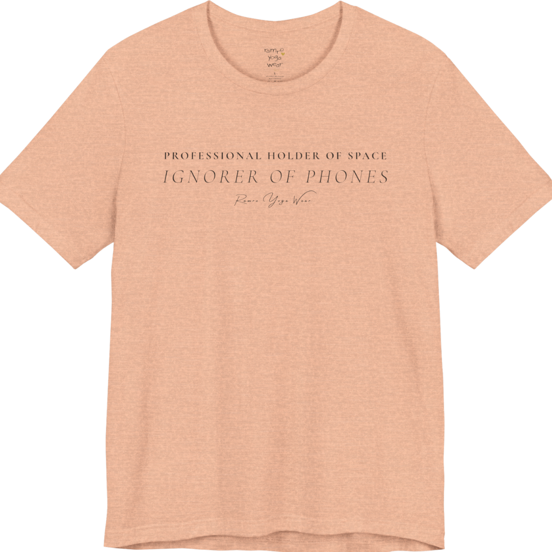 PROFESSIONAL HOLDER OF SPACE IGNORER OF PHONES yoga teacher gift tee flat lay in Heather Peach — Yoga Teacher Gifts collection by Ramro Yoga Wear