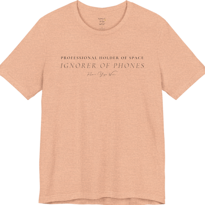 PROFESSIONAL HOLDER OF SPACE IGNORER OF PHONES yoga teacher gift tee flat lay in Heather Peach — Yoga Teacher Gifts collection by Ramro Yoga Wear