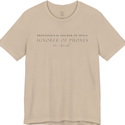 PROFESSIONAL HOLDER OF SPACE IGNORER OF PHONES yoga teacher gift tee flat lay in Tan  — Yoga Teacher Gifts collection by Ramro Yoga Wear