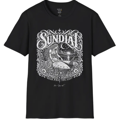 A short sleeved tee called the Sundial T-Shirt, flat lay and a Gildan 64000 shirt. Simply says, Read What You Cast. Design highlights a woman reading a sundial beneath a starry sky, with mountains and a rising sun in the background, in a detailed vintage-inspired illustration. Color is Black.