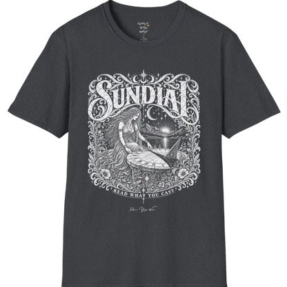 A short sleeved tee called the Sundial T-Shirt, flat lay and a Gildan 64000 shirt. Simply says, Read What You Cast. Design highlights a woman reading a sundial beneath a starry sky, with mountains and a rising sun in the background, in a detailed vintage-inspired illustration. Color is Dark Heather Grey.