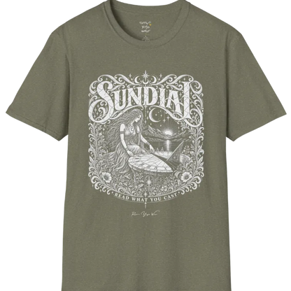 A short sleeved tee called the Sundial T-Shirt, flat lay and a Gildan 64000 shirt. Simply says, Read What You Cast. Design highlights a woman reading a sundial beneath a starry sky, with mountains and a rising sun in the background, in a detailed vintage-inspired illustration. Color is Heather Military Green.