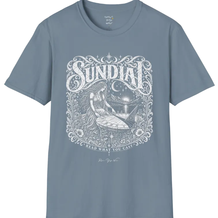 A short sleeved tee called the Sundial T-Shirt, flat lay and a Gildan 64000 shirt. Simply says, Read What You Cast. Design highlights a woman reading a sundial beneath a starry sky, with mountains and a rising sun in the background, in a detailed vintage-inspired illustration. Color is Stone Blue.